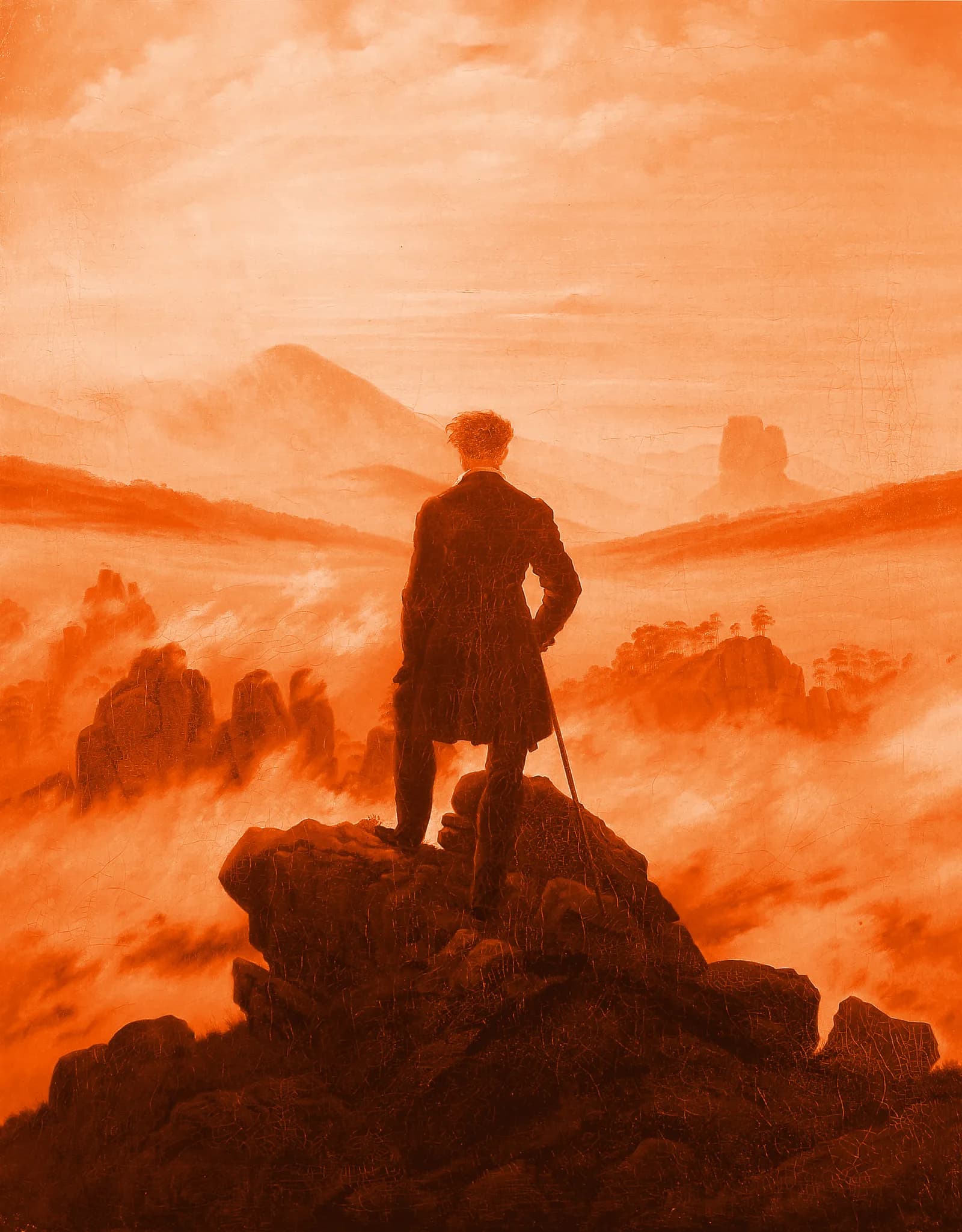 A figure on a rocky summit looking out over a sea of fog